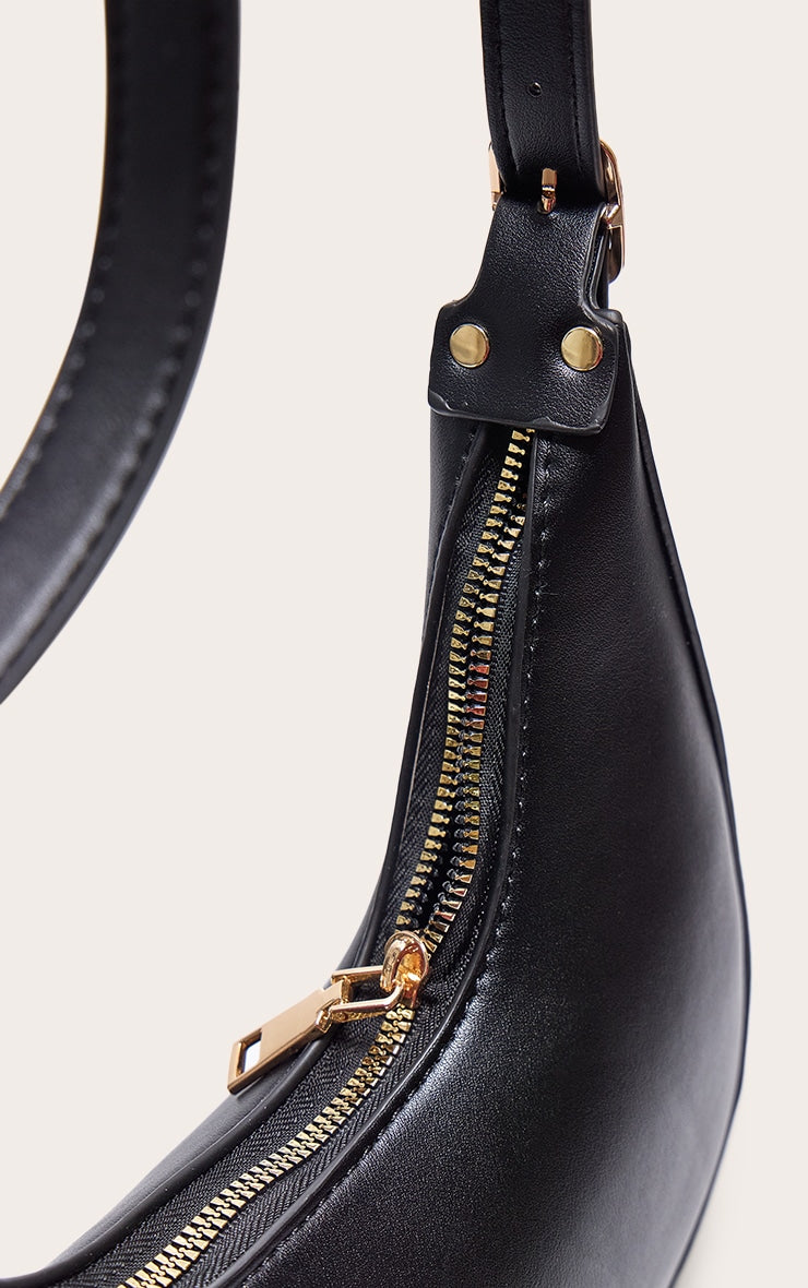 https://cdn-img.prettylittlething.com/f/e/6/8/fe68129ac0549d6f1dfd3b5d82632bbeba386274_CNA1617_4_black_curved_pu_shoulder_bag.jpg